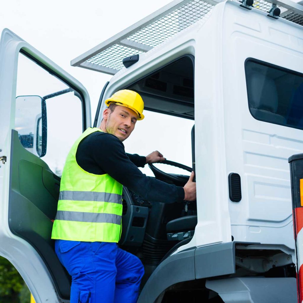 crane operator driving with truck of construction site